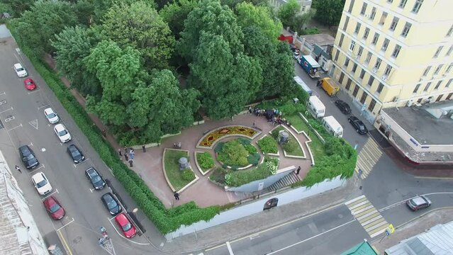Morozovsky garden with people during movie shooting and cars 