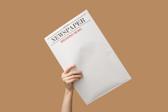 Woman with blank newspaper on brown background