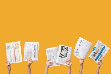 Women with newspapers on yellow background