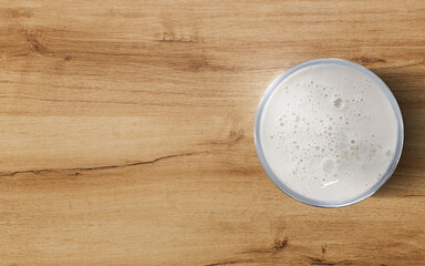 Milk in a glass on a wooden table