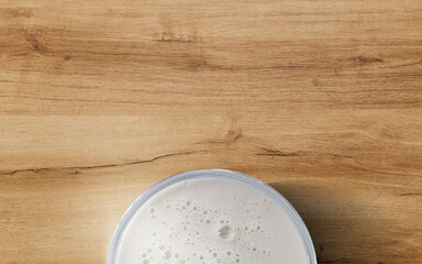 A picture featuring a cup filled with coffee, milk, and tea, set against a wooden table, embodies a variety of refreshing drinks