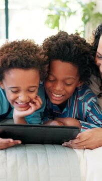 Children, tablet and games on bed, happy and parents with bonding, care or love to relax together. People, kids and digital touchscreen for smile, play or excited for challenge on app in family home