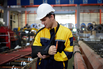 worker or engineer wearing bandages splint, pain in elbow and ache in arm from hard work in the factory