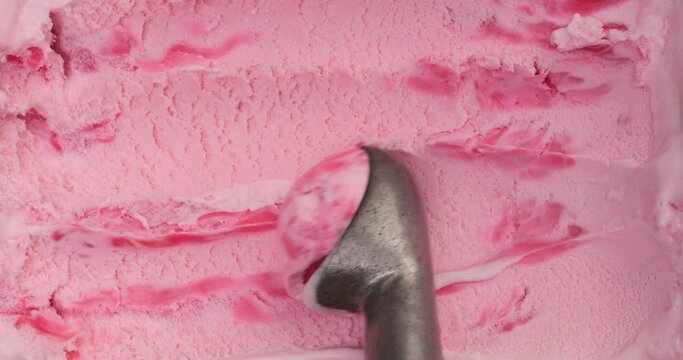 4K footage Close-up Top view, Use a spoon to scoop out straberry ice cream.	