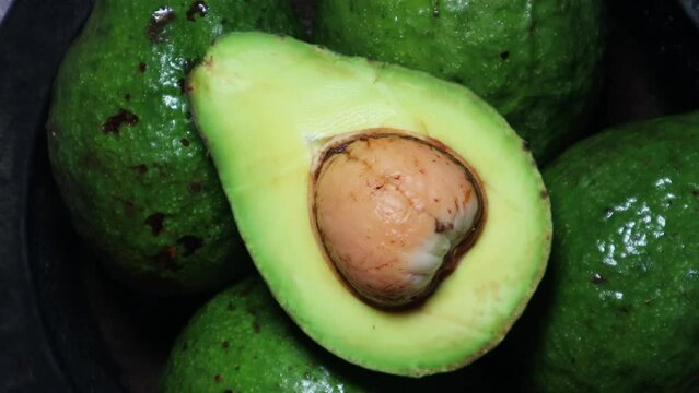 Avocado slice with rotating background. Top view concept.