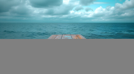 Empty wooden pier overlooking a tranquil sea with cloudy skies, conveying a sense of peace and...