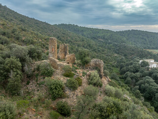 Fototapeta na wymiar Aerial view of Castell de Vilaroma near Palamos on the Costa Brava, hilltop castle ruin with towers above the valley of St Joan de Palamos