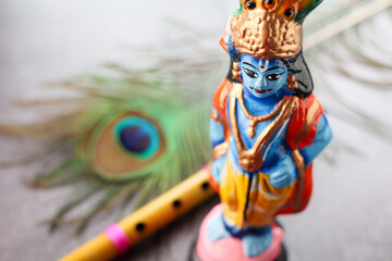Fototapeta na wymiar Sri Krishna statue with peacock feather. Lord Krishna Standing with Flute Vishu festival Kerala