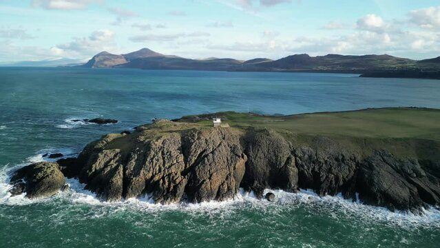 Waves crashing on the beautiful North Wales coastline, sunny winter&rsquo;s day - Aerial Drone rotate around Coastwatch Lookout Station, Nefyn, UK