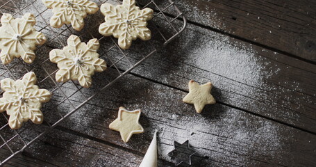 Freshly baked star-shaped cookies cool on a wire rack at home