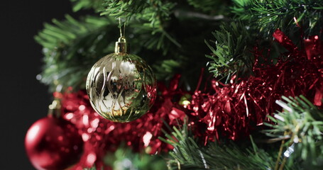A close-up of a Christmas tree adorned with festive decorations