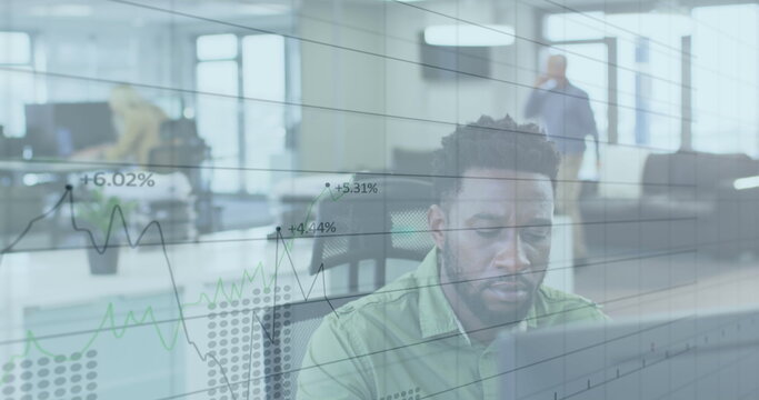 Image of digital interface showing statistics with diverse colleagues working together in an office