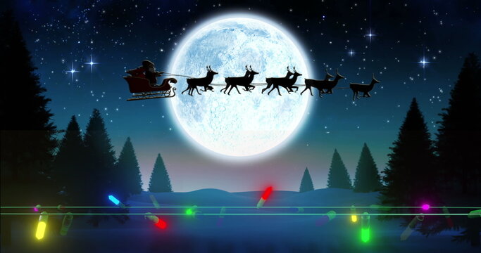 Coloured christmas string lights flashing over winter scene with santa passing full moon in sleigh