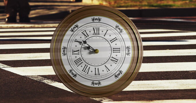 Image of clock ticking over busy zebra crossing