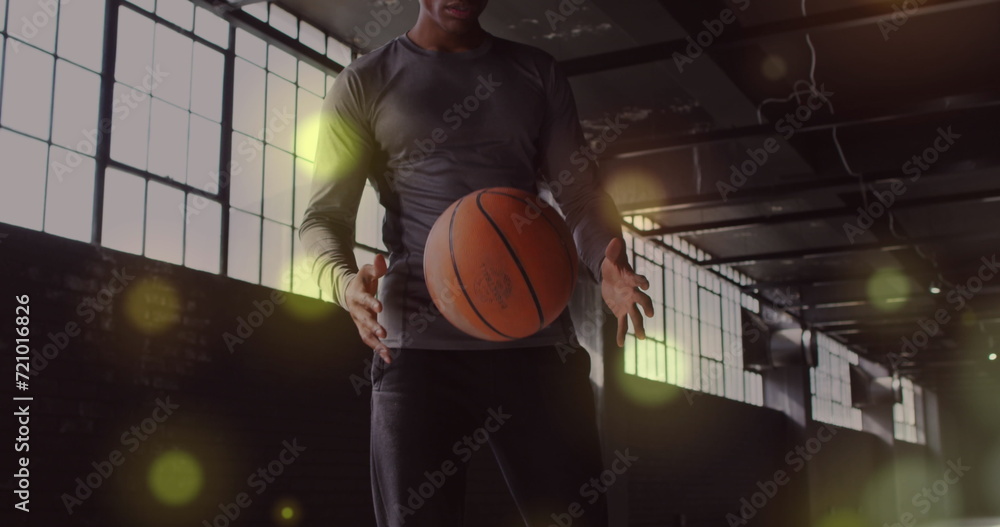 Poster image of golden dots floating over man playing with a ball