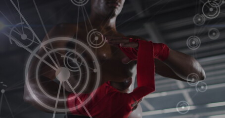 Image of network of connections over man tying ribbons on his hands