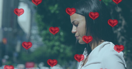 Biracial woman surrounded by heart balloons, with copy space