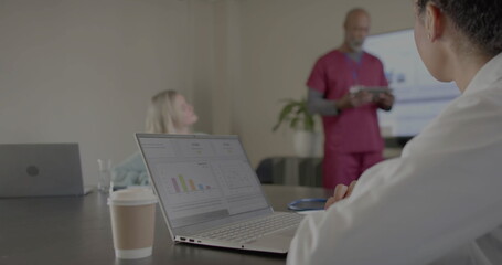 Image of financial data processing over diverse doctors in office