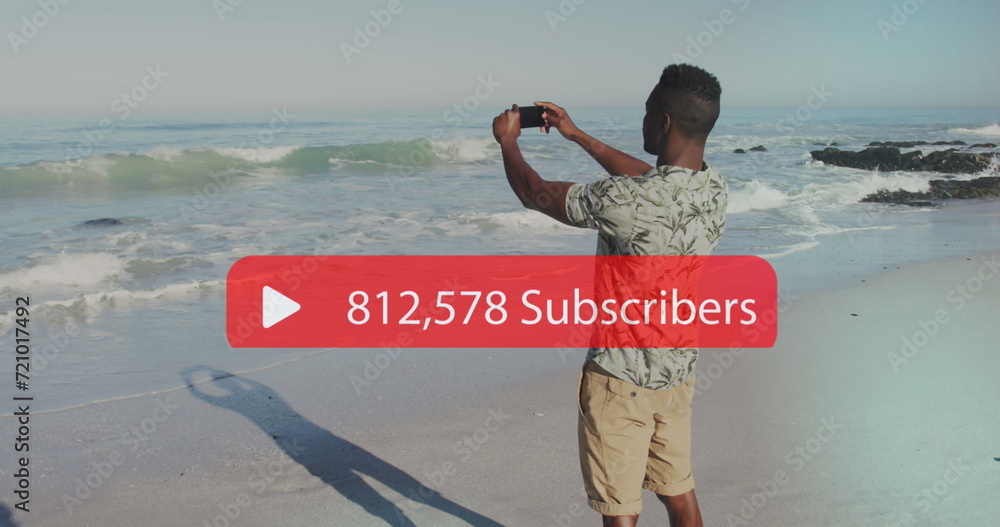 Poster image of speech bubble with subscribers and numbers over man filming sea with smartphone