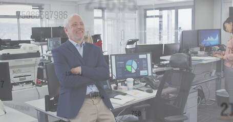 Image of numbers floating, a happy man standing in an office