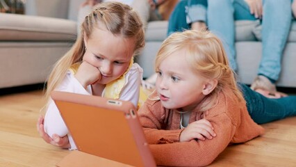 Tablet, search and sisters on a floor with cartoon, games or video, fun and bonding while streaming at home together. Family, kids and siblings in a living room with digital, app or online show