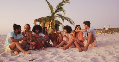 Obraz premium Diverse group of friends enjoy a beach sunset, with copy space