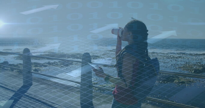 Image of binary data processing over woman walking with smartphone, exercising by seaside - Powered by Adobe