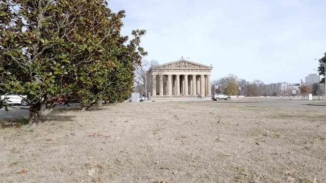Parthenon building in Nashville, Tennessee with drone video moving in at an angle low.