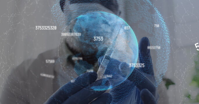 Changing numbers over globe against male doctor tapping on the syringe to remove air bubbles - Powered by Adobe