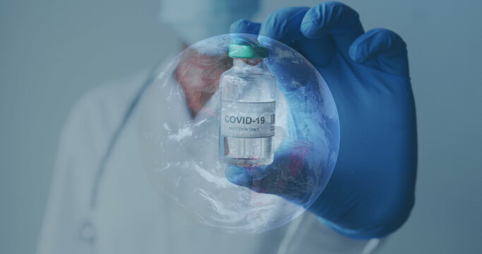 Image of globe with scientist holding covid-19 vaccine wearing face masks