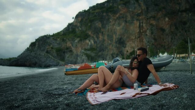 Couple on the beach overlooking sunset