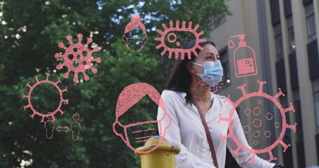 Multiple covid-19 concept icons floating against woman wearing face mask riding bicycle