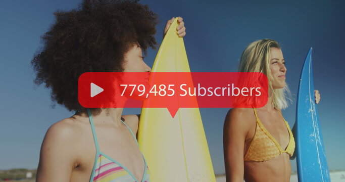 Image of speech bubble with subscribers text and numbers over women with surfboards on beach