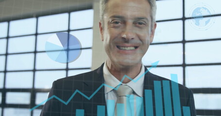 Image of statistics and data processing over caucasian businessman smiling in office