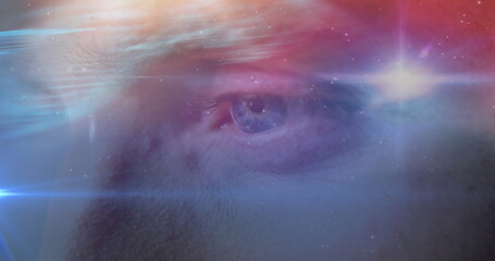 Image of glowing stars and universe over man's face