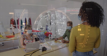 Image of digital interface showing statistics and a covid-19 cell, with colleagues in office wearing