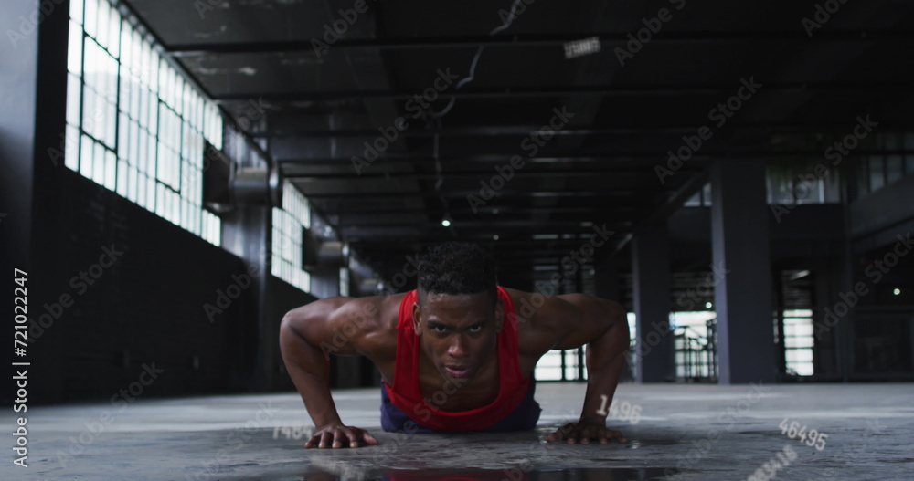 Poster image of falling numbers over man doing push ups in an abandoned building