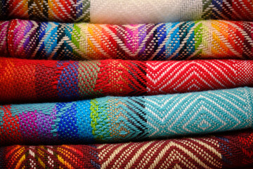 colorful aymara fabrics stacked for souvenirs in la paz bolivia