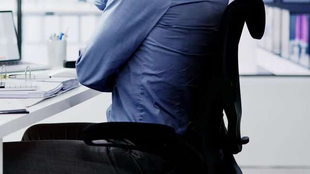 Side View Of Accountant Suffering From Back Pain At Desk