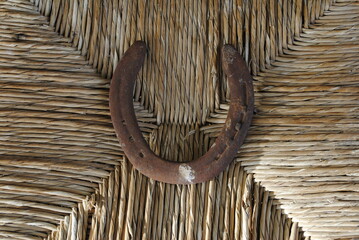 Rusted horseshoe on wicker background close up macro