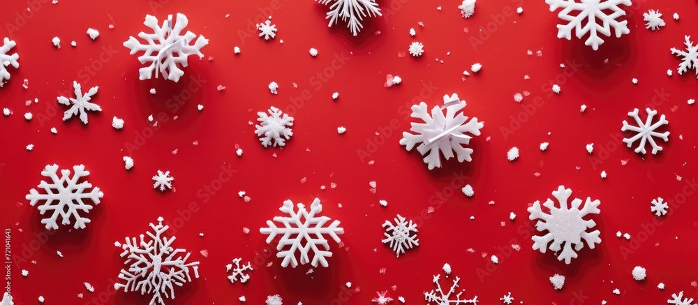 Poster minimal new year pattern with red background and snowflakes in a flat lay.