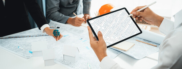 Worker, architect and engineer work on real estate construction project oratory planning with...