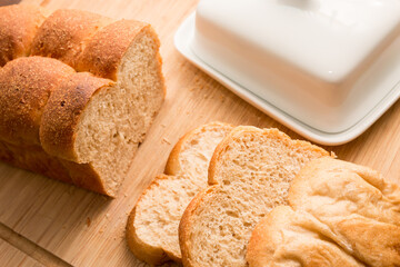 Sliced white Bread on the bamboo desk with butter, homemade bakery concept
