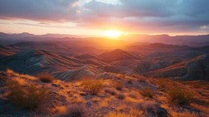 Desert Landscape at Golden Hour with Mountain Range - The sun sets behind a mountain range, casting...