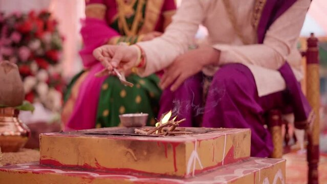 Indian groom and bride performing hindu wedding ritual for marriage ceremony  