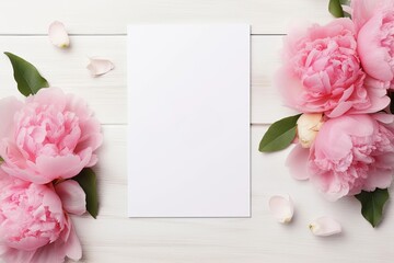 Obraz na płótnie Canvas Blank white greeting card with pink peony flower on bright wooden background. Valentine's day-wedding. Mockup presentation. advertisement. copy text space.