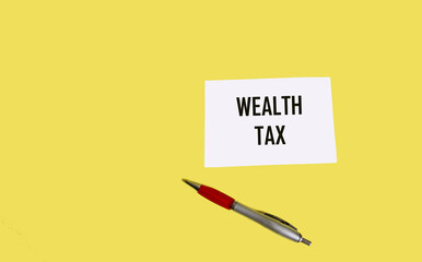 Text BIG TAX on a notepad and yellow background. Business concept