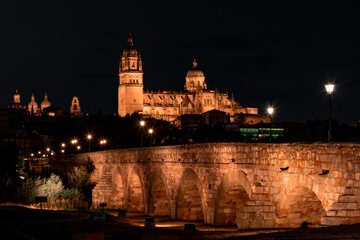 Fototapeta na wymiar Night view of Salamanca cathedral and Roman bridge over Tormes river , Salamanca, Spain.