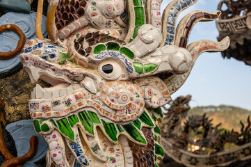Dragon Mosaic Sculpture Adorning Pagoda Temple Rooftop, Architectural Elegance and Cultural...