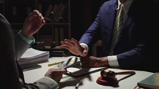 A lawyer a businessman or an accountant is rejecting and resisting the bribery agreement of a partner in a joint financial arrangement. and the concept of resisting illegal bribery in the workplace.
